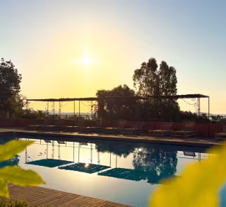 Piscine au coucher du soleil, sous la pergola